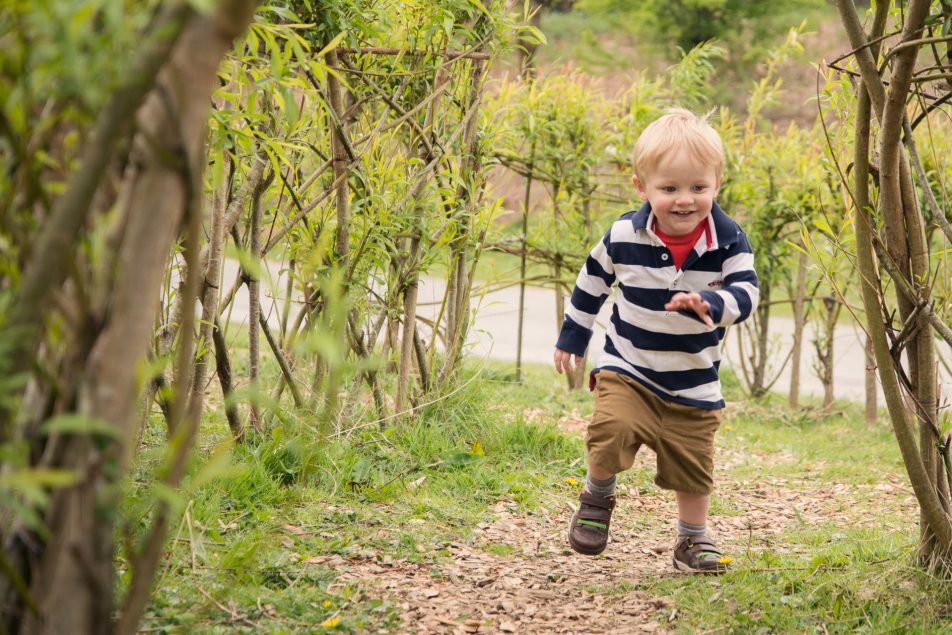 Running child in a play area in pembrokeshire